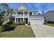 Charming two-story home with a front balcony, attached garage, and manicured landscaping enhancing its curb appeal at 203 Yeamans Way, Summerville, SC 29483
