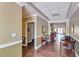 Inviting hallway with wood floors, crown molding, and views of a dining area; fire extinguisher nearby at 203 Yeamans Way, Summerville, SC 29483