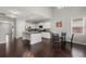 Open-concept kitchen with island, stainless appliances, white cabinets, and an adjacent dining area at 203 Yeamans Way, Summerville, SC 29483