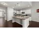 Bright kitchen with an island, stainless appliances, granite counters, and ample cabinet space at 203 Yeamans Way, Summerville, SC 29483