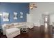Living room with blue accent wall, comfortable sectional sofa and high ceilings at 203 Yeamans Way, Summerville, SC 29483