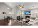 Living room with fireplace, large TV, comfortable sectional sofa, and open view to the dining area at 203 Yeamans Way, Summerville, SC 29483