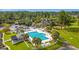 Aerial view of a stunning pool with lounge chairs and a clubhouse, surrounded by lush greenery and landscaping at 203 Yeamans Way, Summerville, SC 29483