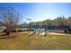 View of the community tennis courts with shaded seating areas and lush greenery, a great place to relax and play at 203 Yeamans Way, Summerville, SC 29483