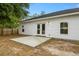 White home exterior with a new concrete patio and a well maintained and landscaped backyard at 204 Read St, Moncks Corner, SC 29461