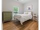 Cozy bedroom with wood floors, a window, and brass bed frame with a dresser at 204 Read St, Moncks Corner, SC 29461