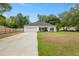 Inviting single-story house with a manicured front yard, long driveway, and a welcoming entrance with black shutters at 204 Read St, Moncks Corner, SC 29461