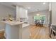 Modern kitchen featuring white cabinets, stainless steel appliances, marble countertops, and a breakfast nook area at 204 Read St, Moncks Corner, SC 29461