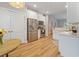 Well-lit kitchen with stainless steel appliances, white cabinets, wood floors, and a cozy breakfast nook at 204 Read St, Moncks Corner, SC 29461
