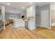 Open-concept kitchen with white cabinetry, stainless steel appliances, counter seating, and a view of the living room at 204 Read St, Moncks Corner, SC 29461