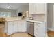 Bright kitchen featuring marble countertops, white cabinets and stainless steel dishwasher at 204 Read St, Moncks Corner, SC 29461