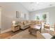Bright living room with high ceilings, a comfortable sectional sofa, wood floors, and a light-colored area rug at 204 Read St, Moncks Corner, SC 29461