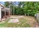 Backyard view with a fire pit and screened porch beyond a wood pergola at 209 Lipman St, Summerville, SC 29483
