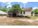 Backyard featuring a screened porch, mature shade trees, and ample sunlight at 209 Lipman St, Summerville, SC 29483