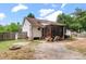 Backyard featuring a screened porch, a fire pit, and a wood pile at 209 Lipman St, Summerville, SC 29483