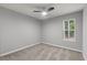 Neutral bedroom with carpet, paint, and trim has a ceiling fan and window to the outdoors at 209 Lipman St, Summerville, SC 29483