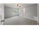 Large bedroom with neutral carpet, paint, and trim has a ceiling fan and window to the outdoors at 209 Lipman St, Summerville, SC 29483