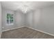 Bedroom features neutral carpet, paint, and trim with a chandelier and window at 209 Lipman St, Summerville, SC 29483