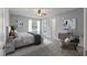 Staged bedroom with neutral carpet, paint, and trim has a ceiling fan and window to the outdoors at 209 Lipman St, Summerville, SC 29483
