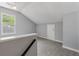 Well-lit bonus room features neutral paint, carpet, trim, and a window bringing the outdoors in at 209 Lipman St, Summerville, SC 29483
