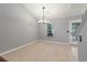 Bright dining area with tiled floors has a modern chandelier, window, and a back door that leads to the deck at 209 Lipman St, Summerville, SC 29483