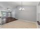 Open dining area with tiled flooring, lots of natural light, chandelier, and easy access to front door and living room at 209 Lipman St, Summerville, SC 29483