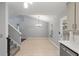 Dining area has tile flooring, a chandelier, a large window, and is open to a stairway, back door, and the kitchen at 209 Lipman St, Summerville, SC 29483