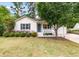 Charming single-story home with light siding, blue door, manicured landscaping, and attached garage at 209 Lipman St, Summerville, SC 29483