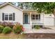 Charming single-story home with light siding, blue door, front porch and manicured landscaping at 209 Lipman St, Summerville, SC 29483