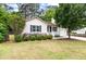 Charming single-story home with light siding, blue door, manicured landscaping, and attached garage at 209 Lipman St, Summerville, SC 29483