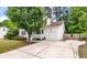 Charming single-story home with light siding, blue door, manicured landscaping, and attached garage at 209 Lipman St, Summerville, SC 29483