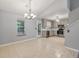 Open dining area with tiled flooring, chandelier, stainless appliances, stone backsplash and convenient access to the kitchen at 209 Lipman St, Summerville, SC 29483
