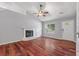 Bright living room boasts a cozy fireplace, gleaming hardwood floors, and neutral paint at 209 Lipman St, Summerville, SC 29483