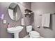 Bathroom with pedestal sink, oval mirror, shelving, towel rack and toilet at 2121 Egret Crest Ln, Charleston, SC 29414
