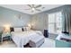 Bright bedroom with a comfortable bed, ceiling fan, and ample natural light from the window at 2121 Egret Crest Ln, Charleston, SC 29414