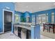 Open clubhouse bar area with blue walls, white tile floors, and an undercounter fridge at 2121 Egret Crest Ln, Charleston, SC 29414