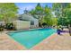 Community pool surrounded by lounge chairs and lush landscaping under a clear sky at 2121 Egret Crest Ln, Charleston, SC 29414