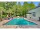 Resort-style community pool surrounded by mature trees and lounge seating at 2121 Egret Crest Ln, Charleston, SC 29414