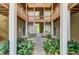 Charming courtyard with stone pavers, wooden benches, and verdant tropical plants at 2121 Egret Crest Ln, Charleston, SC 29414
