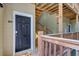 Close-up of a unit entrance with a black door and wooden railing at 2121 Egret Crest Ln, Charleston, SC 29414