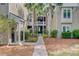 Welcoming pathway between buildings, framed by palm trees and lush landscaping at 2121 Egret Crest Ln, Charleston, SC 29414