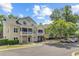 Inviting two-story townhomes with covered porches and attached garages on a sunny day at 2121 Egret Crest Ln, Charleston, SC 29414