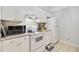 Well-lit kitchen with white appliances and tile flooring at 2121 Egret Crest Ln, Charleston, SC 29414
