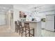Kitchen island bar with seating, 'Coffee' decor, and view to hall at 2121 Egret Crest Ln, Charleston, SC 29414