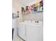 Laundry room with neatly arranged shelves and modern washer and dryer appliances at 2121 Egret Crest Ln, Charleston, SC 29414