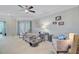 Comfortable living room with carpet, neutral tones, ceiling fan, and access to a balcony at 2121 Egret Crest Ln, Charleston, SC 29414