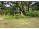 Picturesque backyard with vintage brick, offering a tranquil outdoor retreat with mature trees at 2128 Golfview Dr, Charleston, SC 29412