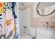 Stylish bathroom featuring a shower-tub combo, round mirror, and elegant sink, designed for relaxation at 2128 Golfview Dr, Charleston, SC 29412