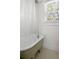 Classic bathroom featuring a vintage-style clawfoot tub with a shower and a window, offering a bright and airy feel at 2128 Golfview Dr, Charleston, SC 29412