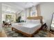 Bright bedroom featuring a white bed, desk, chair and a large bay window, offering a relaxing atmosphere at 2128 Golfview Dr, Charleston, SC 29412
